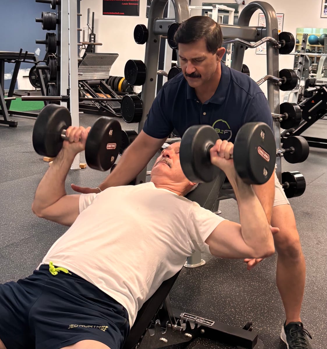 Scott coaching a client during an incline dumbbell press